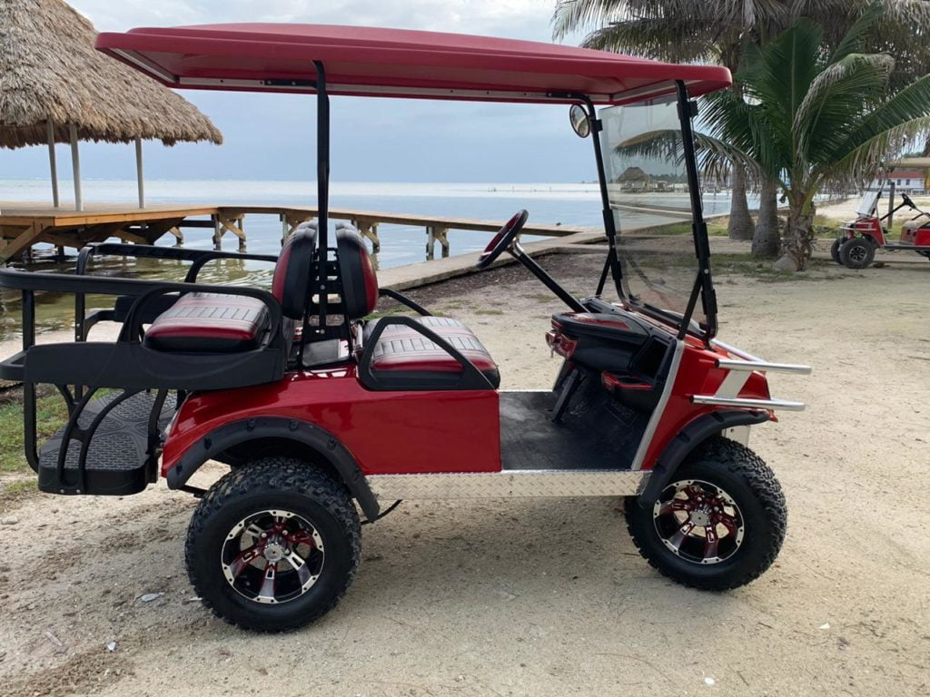 Red golf cart on the beach of San Pedro